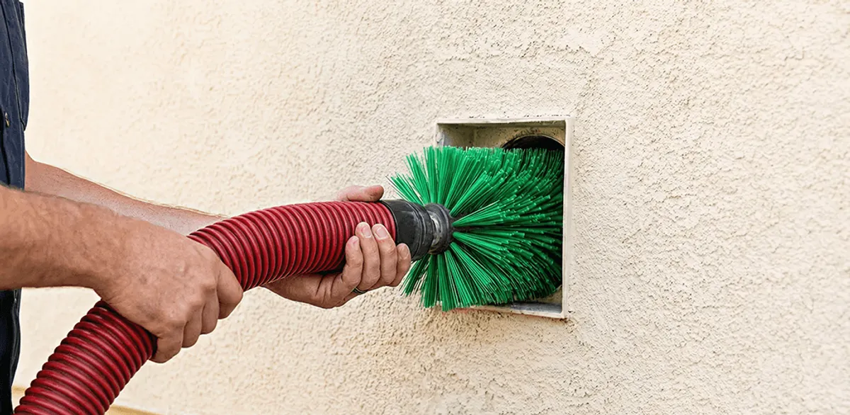 Air duct cleaning brush removing debris from a vent opening in Manchester, NH