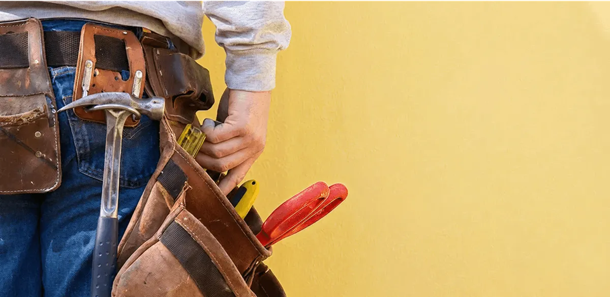 Handyman with tool belt ready for home repairs and maintenance in Manchester, NH