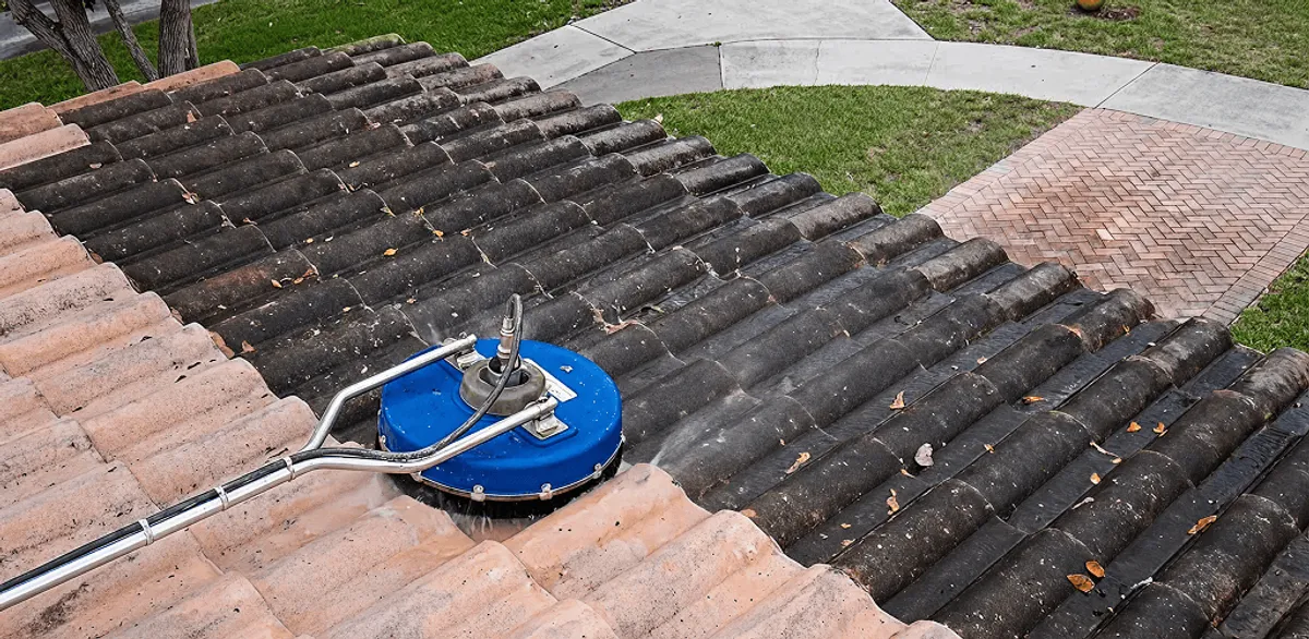 Roof pressure cleaning removing debris and buildup from roof tiles in Manchester, NH