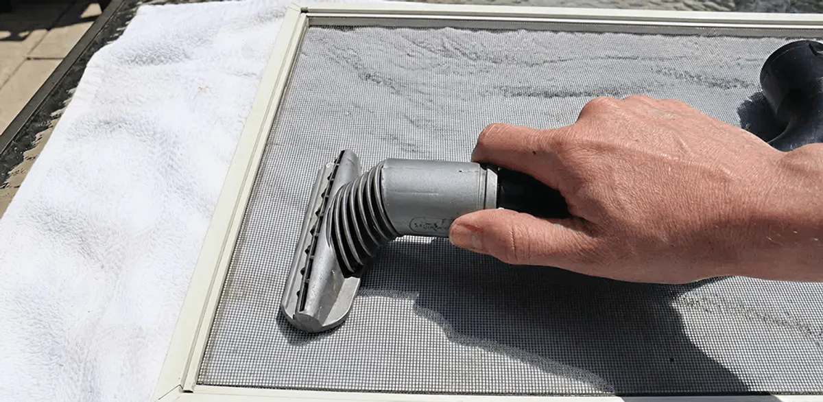 Window screen repair cleaning and fixing a damaged screen mesh in Manchester, NH